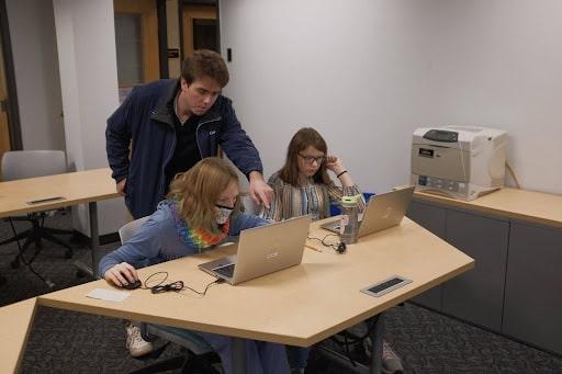 a DTI member teaching members of the Ithaca community about technology at the Tompkins County Public Library